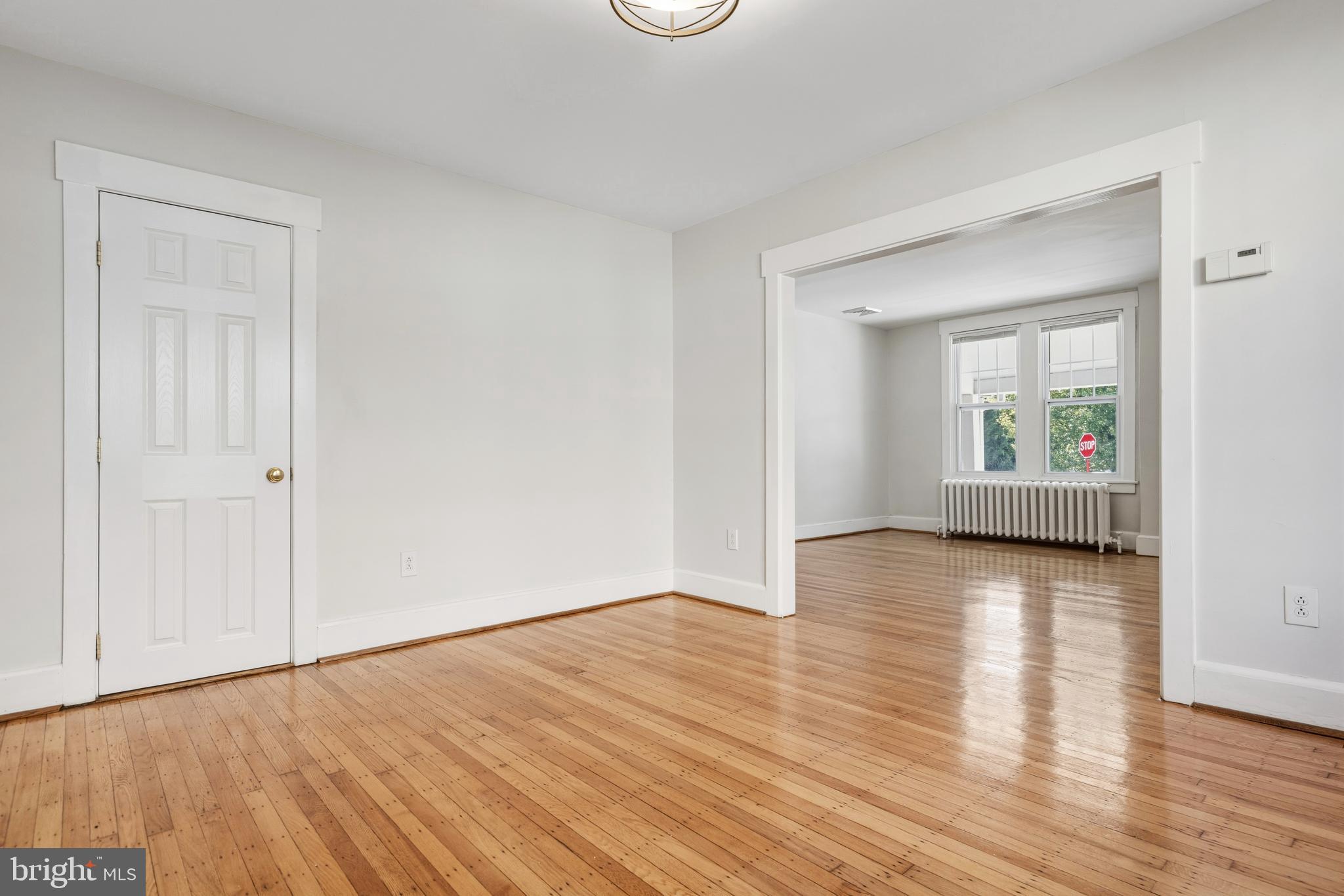 229 Wayne Avenue Narberth, PA 19072 - Photo 13 of 35 a view of an empty room with wooden floor and a window