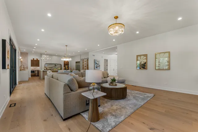 a living room with furniture kitchen and a table