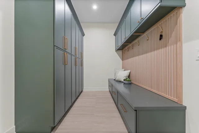 a hallway with front door wooden floor and stairs