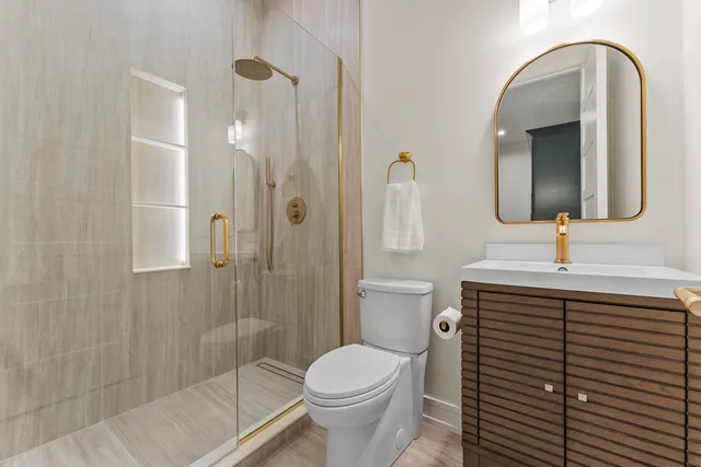 a bathroom with a sink toilet and shower