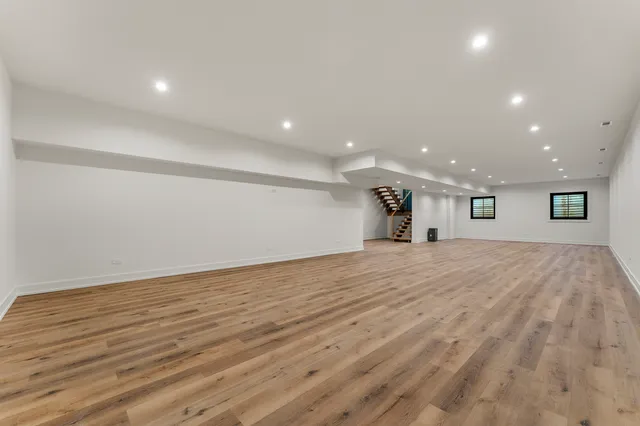 a living room with furniture floor to ceiling window and a flat screen tv