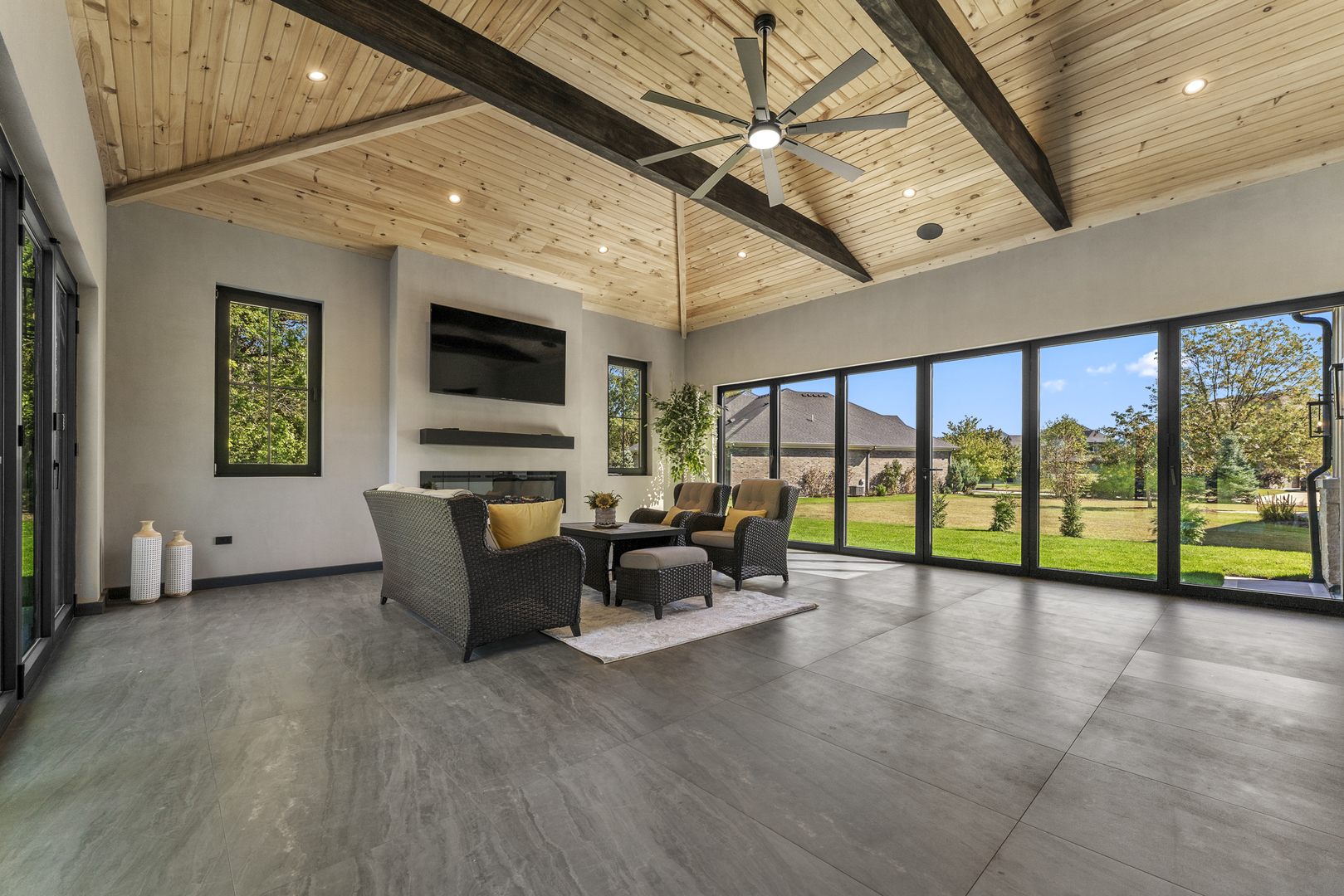 1504 Linden Circle Lemont, IL 60439 - Photo 40 of 54 a living room with furniture floor to ceiling window and a flat screen tv