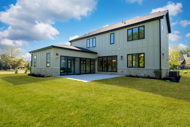 an aerial view of a house with a garden and yard