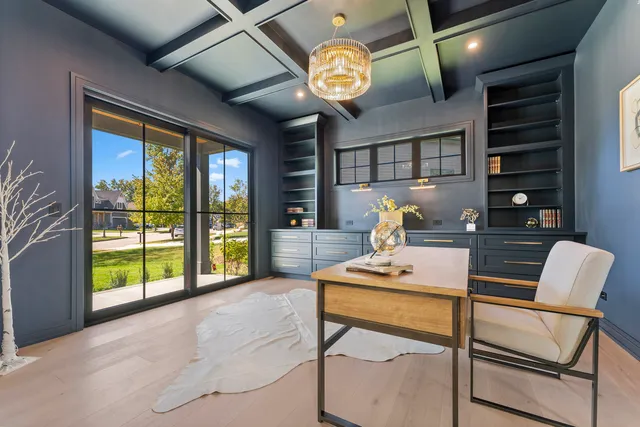 a workspace with furniture and a large window