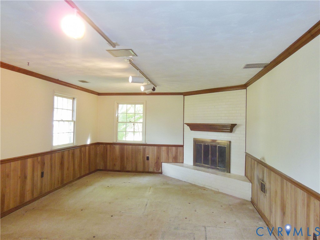 8218 Overbury Road Richmond, VA 23227 - Photo 19 of 37 a view of an empty room with a fireplace and a window