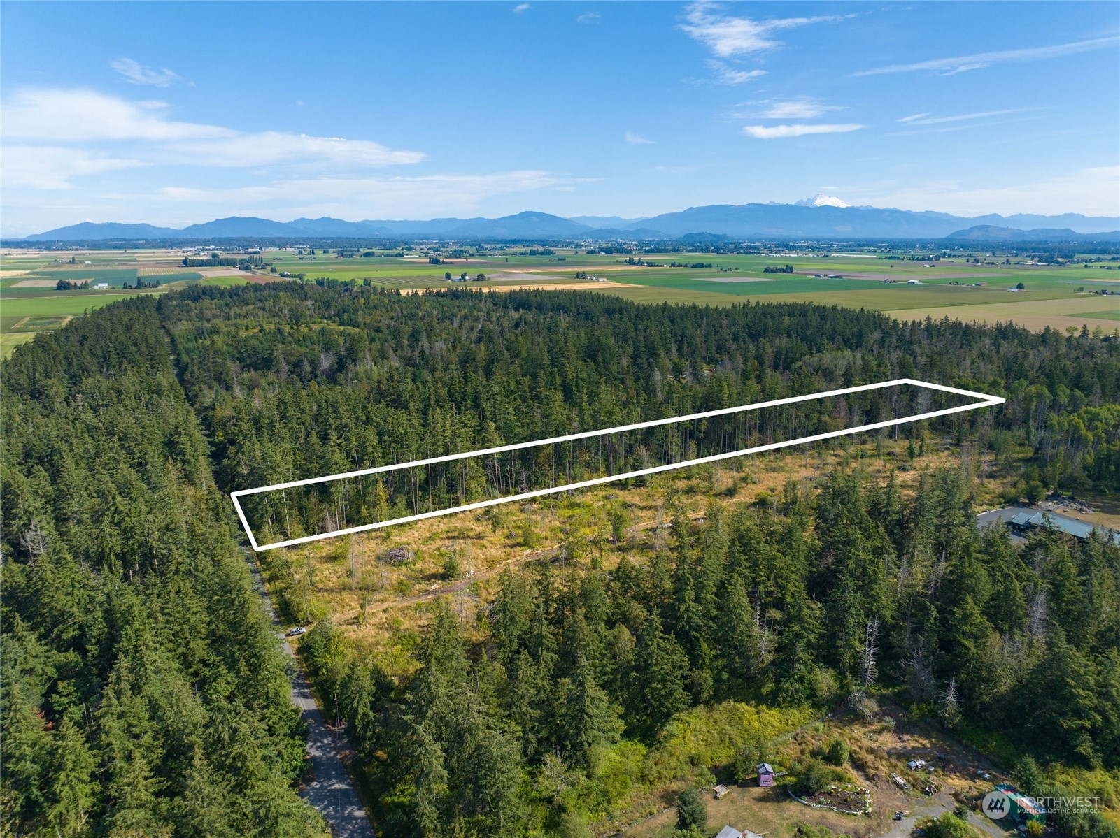 0 Valentine Road Mount Vernon, WA 98273 - Photo 6 of 6 a view of a city and mountains next to a lake