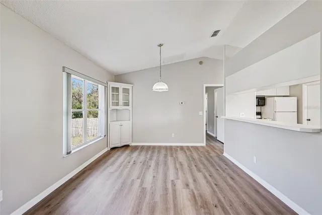 a view of a room with wooden floors and window