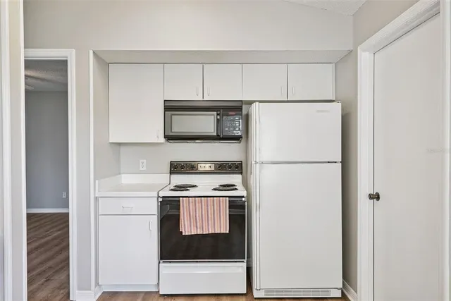 a kitchen with a refrigerator stove and microwave
