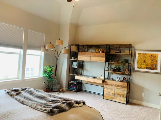 a bedroom with bed and window