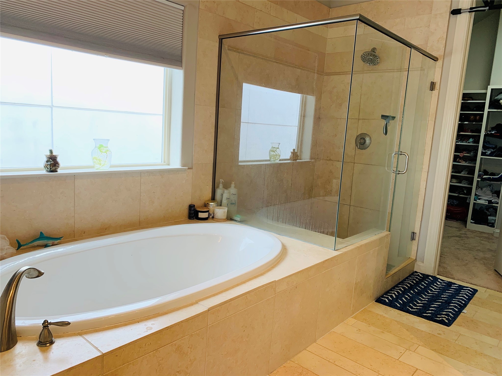 5709 Arabelle Lake Street Houston, TX 77007 - Photo 13 of 20 a bathroom with a bathtub and a shower