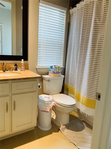 a bathroom with a sink toilet and mirror