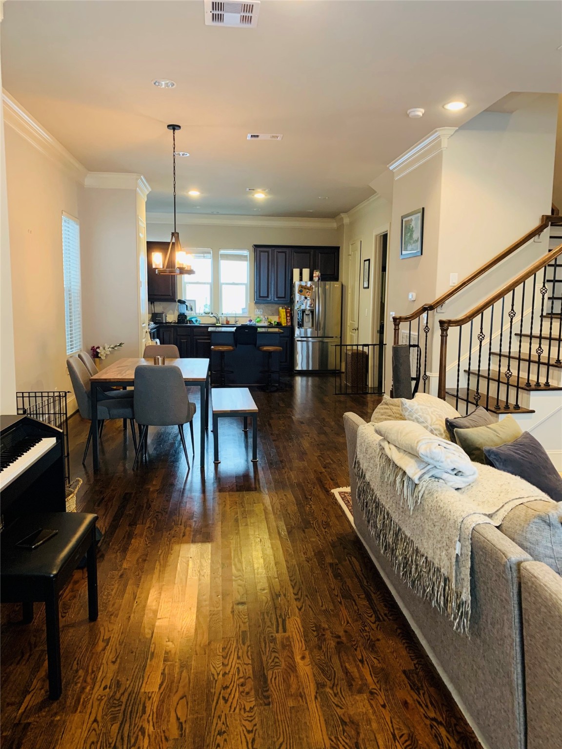 5709 Arabelle Lake Street Houston, TX 77007 - Photo 8 of 20 a living room with couches a dining table with wooden floor