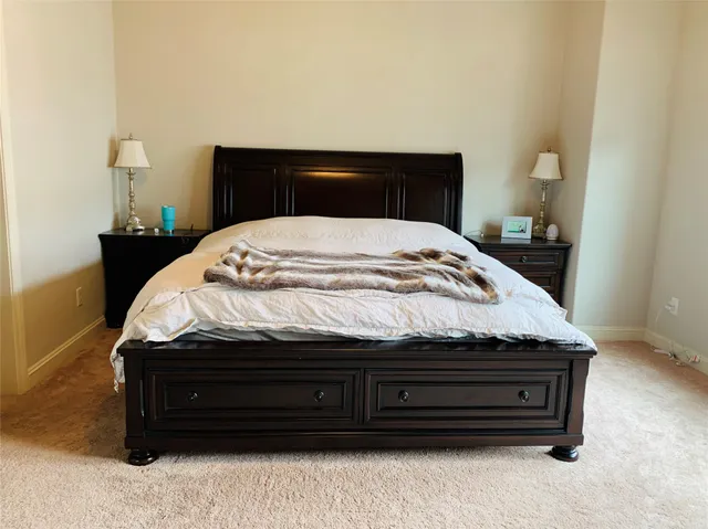 a bedroom with a bed and a night stand