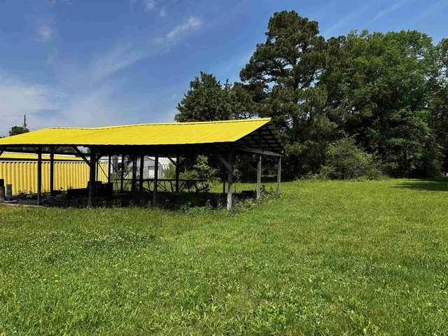 a view of yard with swimming pool and table and chairs