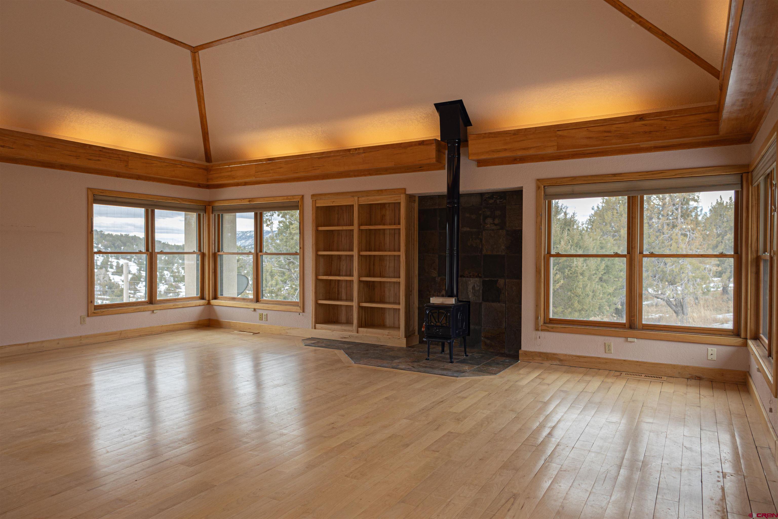 40926 Rd J Mancos, CO 81328 - Photo 4 of 15 a view of an empty room with a window and wooden floor