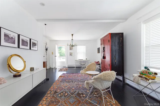 a large white kitchen with a large window and kitchen view