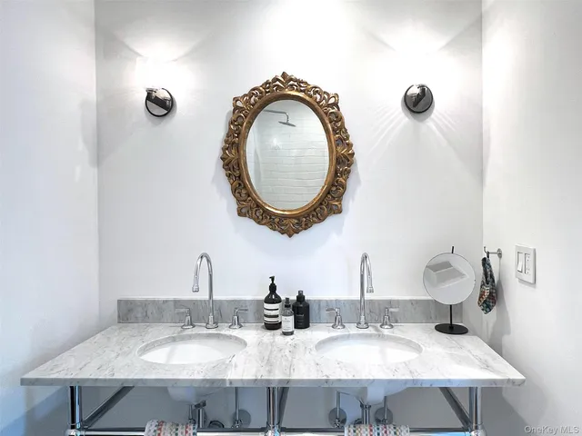 a bathroom with a granite countertop shower and a toilet