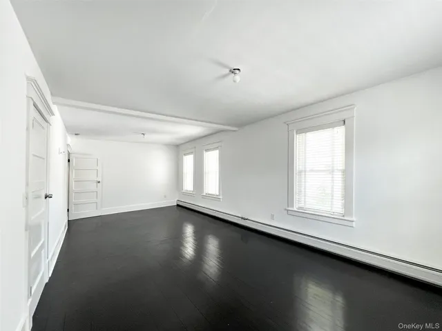 an empty room with a gallery and wooden floor