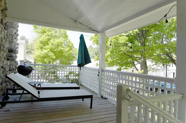 a view of a deck with wooden floor and outdoor seating