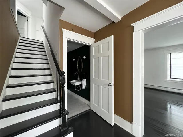 a living room with dining room and wooden floor