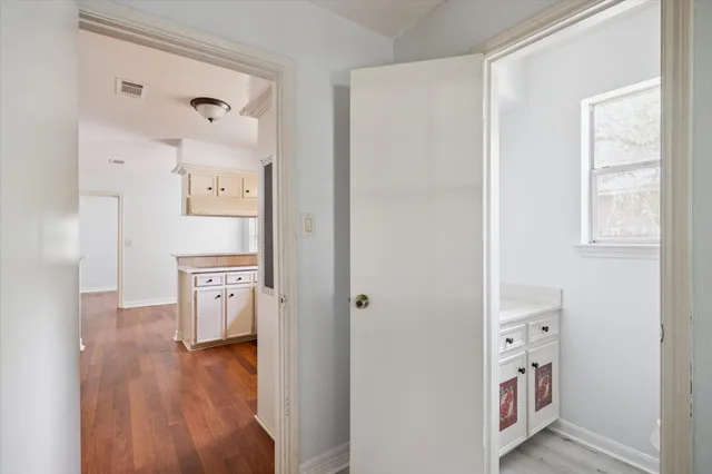 a kitchen with cabinets and a wooden floor