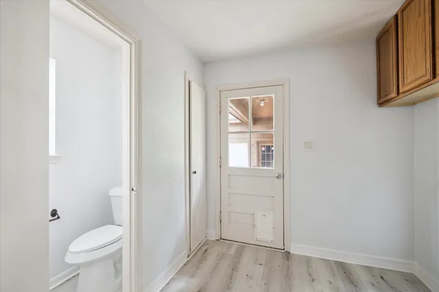 a bathroom with a granite countertop toilet and a sink