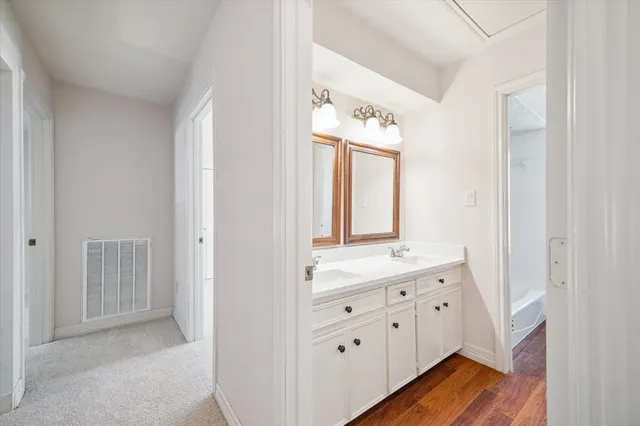 a spacious bathroom with a double vanity sink mirror and