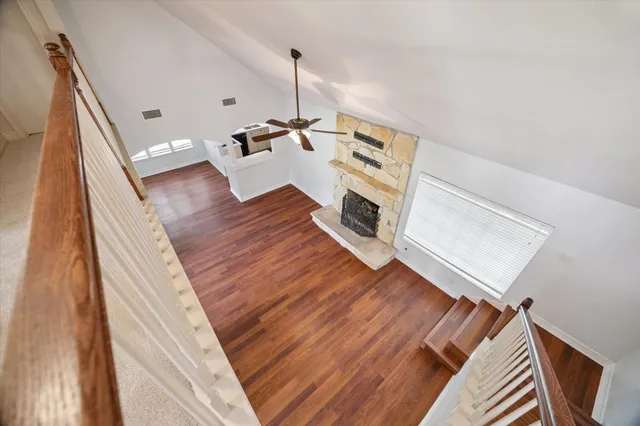 a view of a living room with furniture and a fireplace