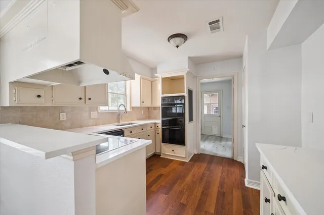 a kitchen with stainless steel appliances a refrigerator and a stove top oven