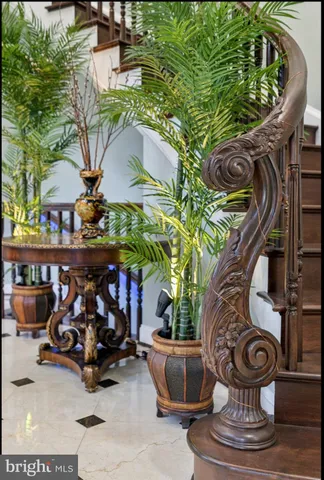 a large kitchen with stainless steel appliances kitchen island granite countertop a large stove a sink dishwasher and white cabinets with wooden floor