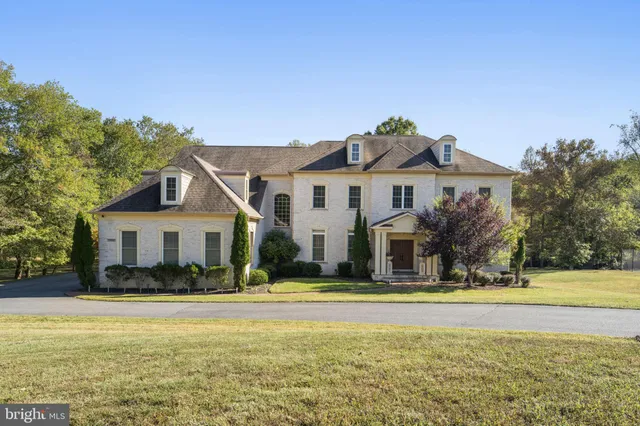 a front view of a house with swimming pool and glass windows