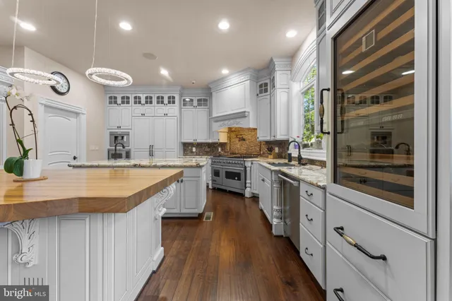 a living room with fireplace furniture and a large window