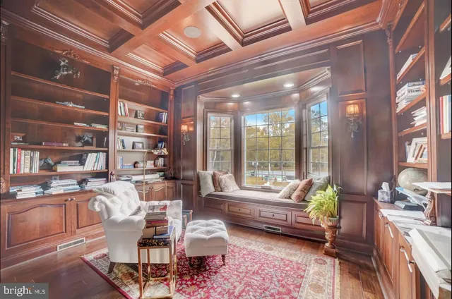 a living room with furniture a wooden floor and a large window