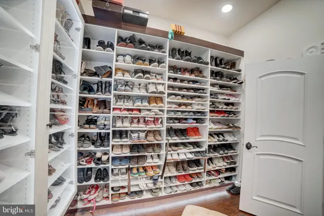 a spacious bathroom with a double vanity sink a large mirror a shower and bathtub