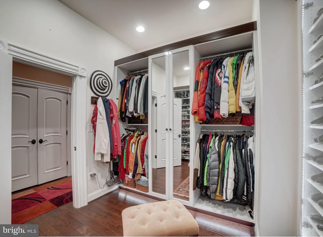 11561 Stuart Mill Road Oakton, VA 22124 - Photo 36 of 76 a view of walk in closet with clothes and shoes