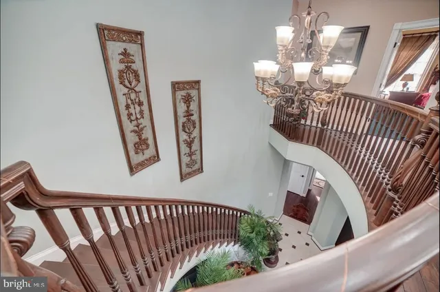 a view of a hallway with windows and chandelier