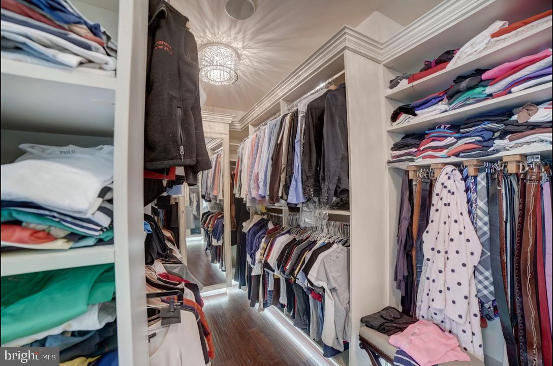 11561 Stuart Mill Road Oakton, VA 22124 - Photo 46 of 76 a view of walk in closet with clothes and shoes