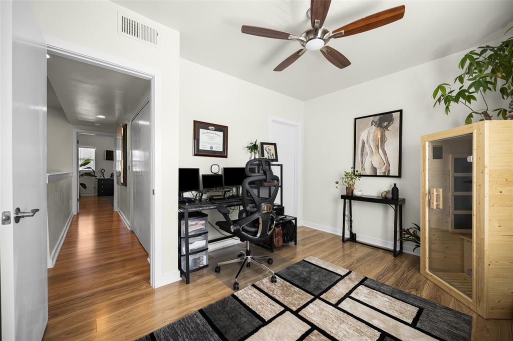 3922 Gilbert Avenue, Unit 214 Dallas, TX 75219 - Photo 16 of 27 Light wood-finish flooring complements neutral wall tones