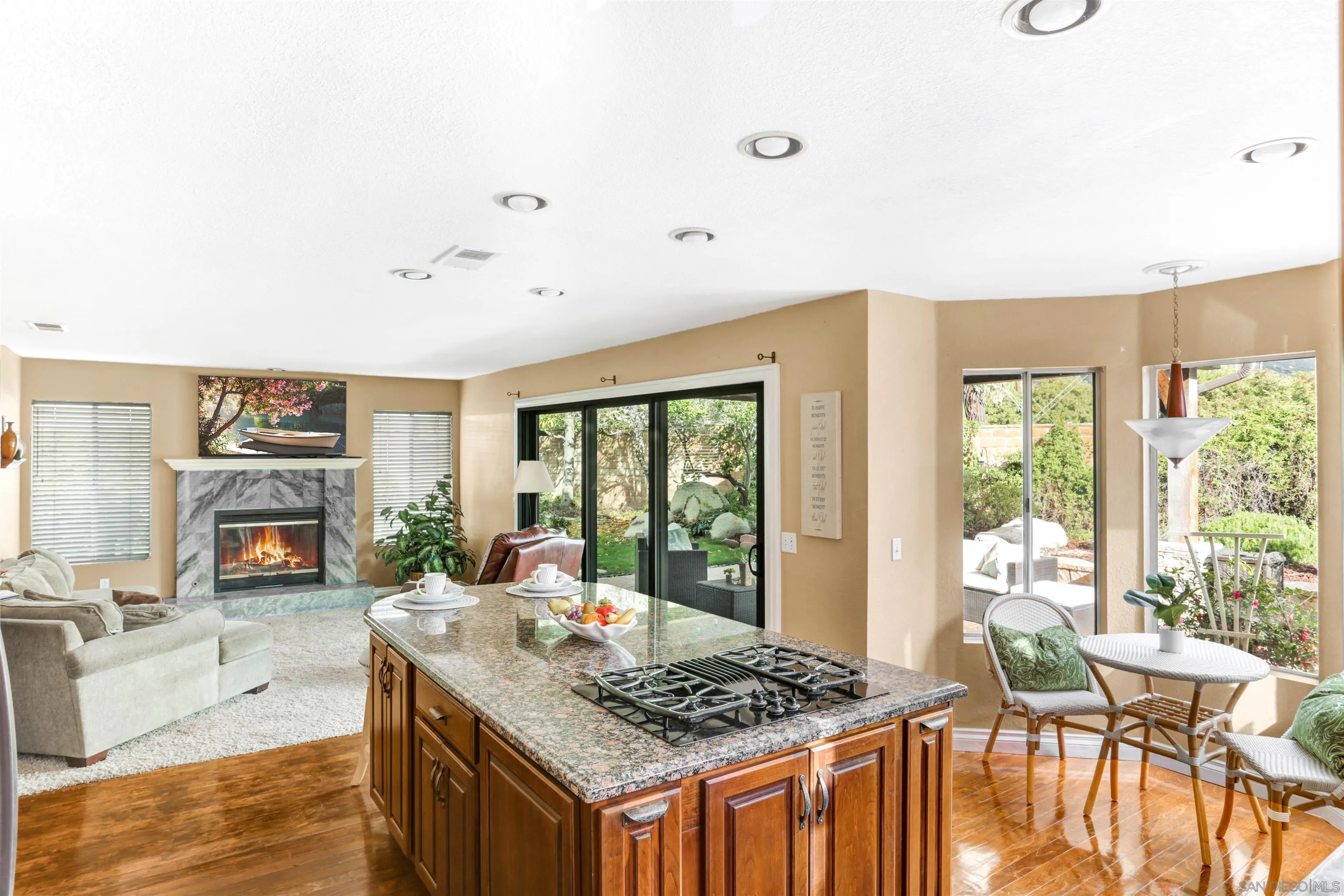 14153 Rio Court Poway, CA 92064 - Photo 13 of 48 a kitchen with a stove a refrigerator a dining table and chairs with the floor to ceiling window