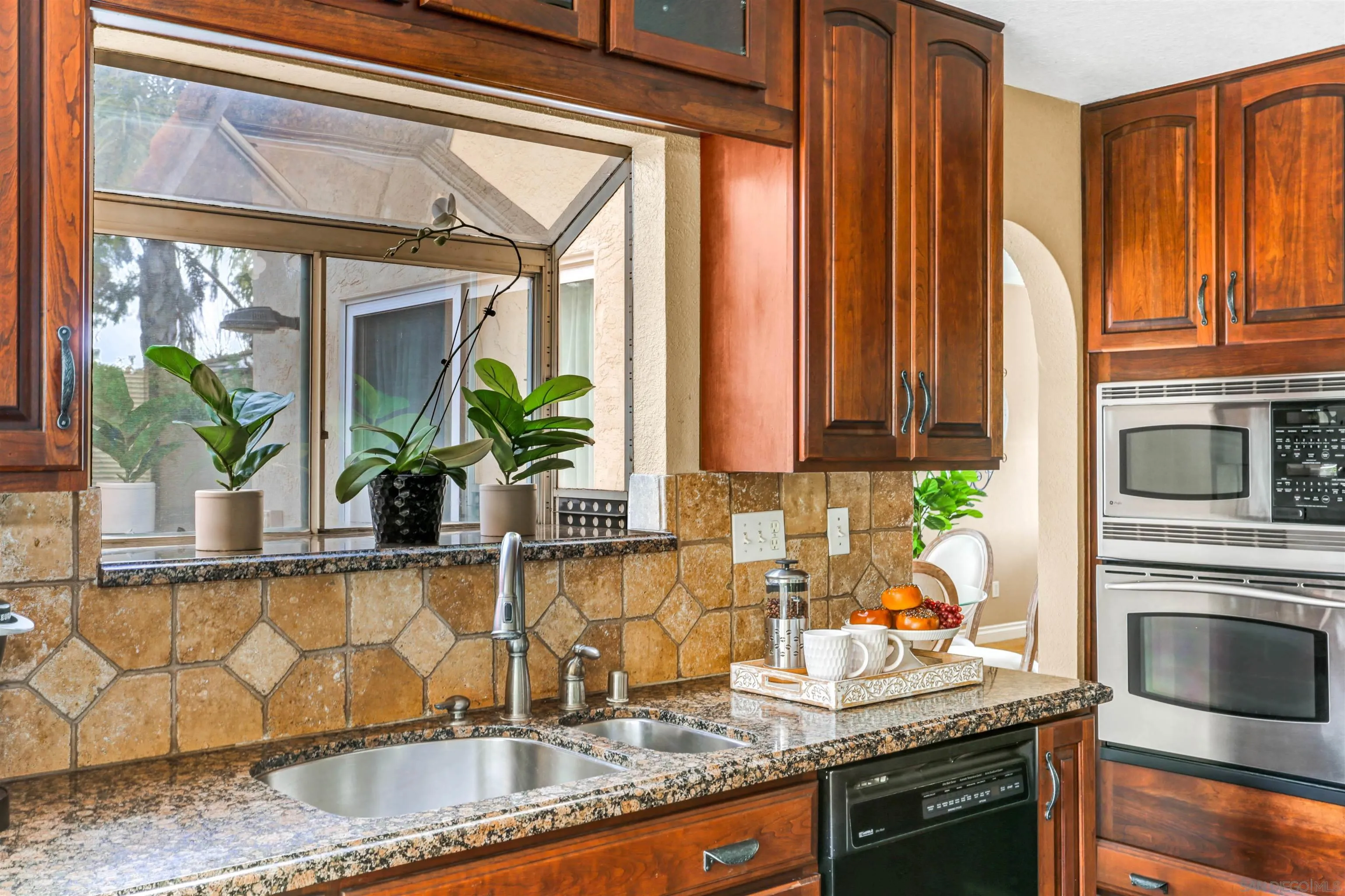 14153 Rio Court Poway, CA 92064 - Photo 16 of 48 a kitchen with granite countertop a sink and a stove
