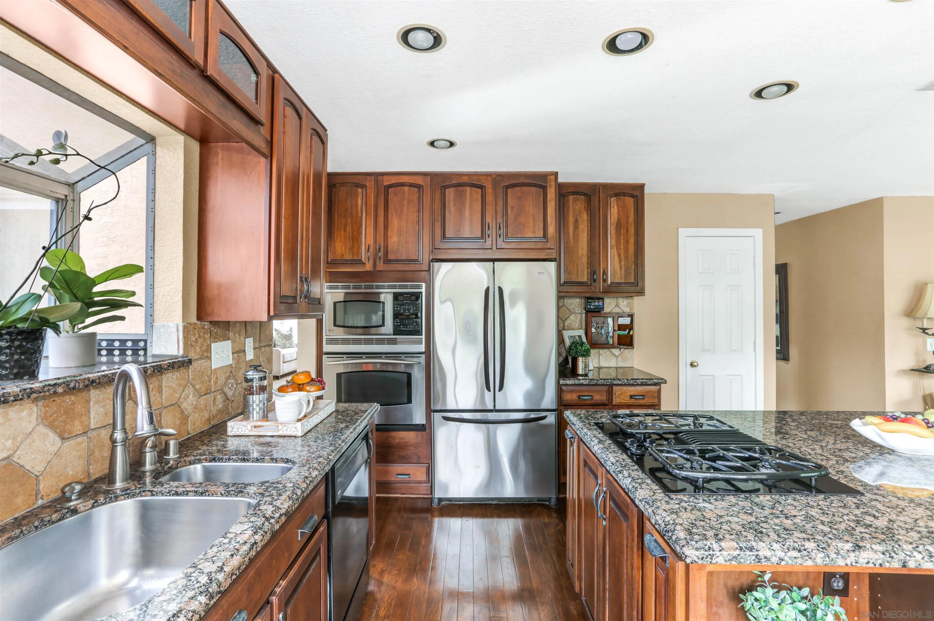 14153 Rio Court Poway, CA 92064 - Photo 17 of 48 a kitchen with granite countertop a sink stove and refrigerator
