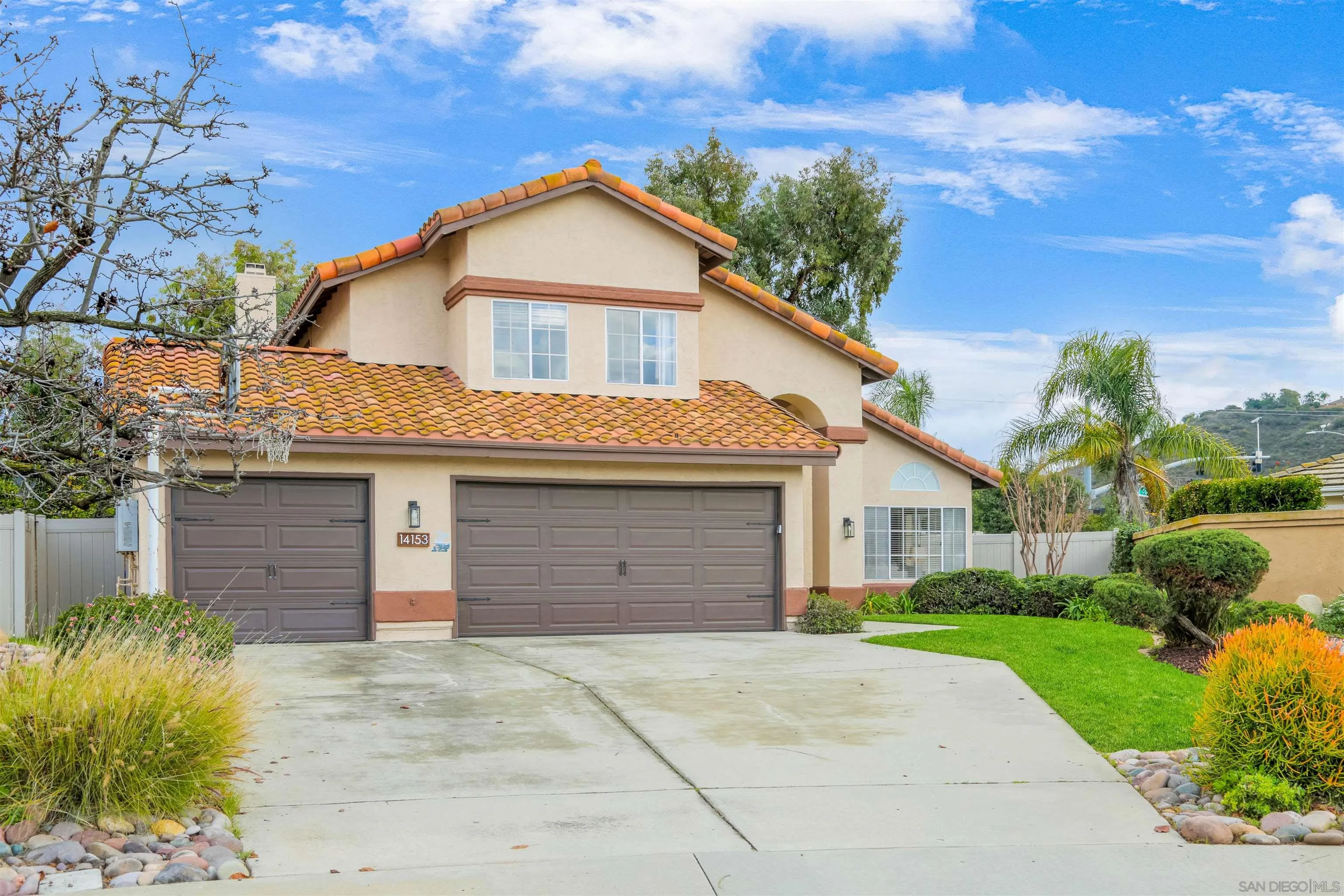 14153 Rio Court Poway, CA 92064 - Photo 2 of 48 a front view of a house with a yard and garage