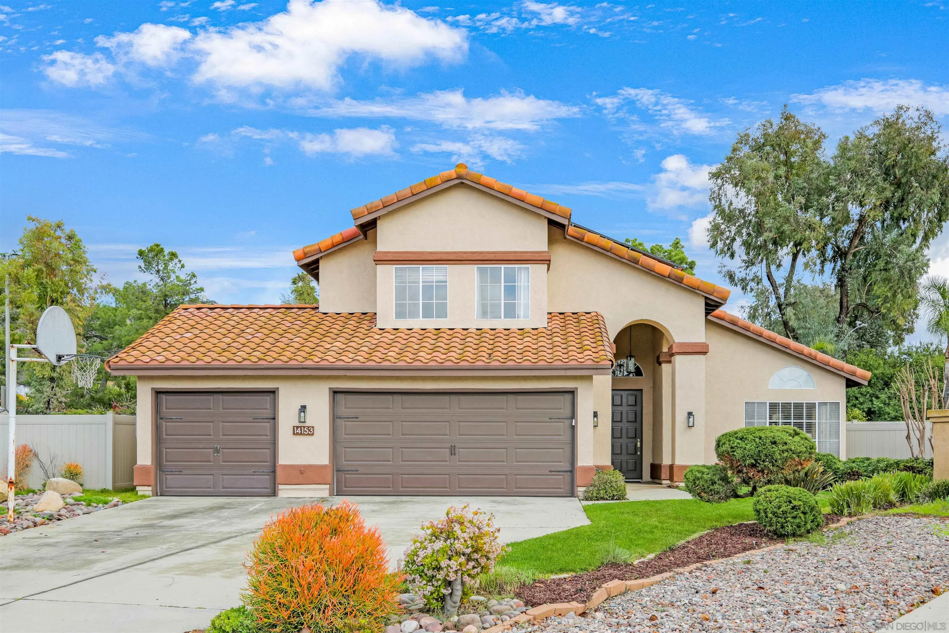 14153 Rio Court Poway, CA 92064 - Photo 3 of 48 a front view of a house with a yard and garage