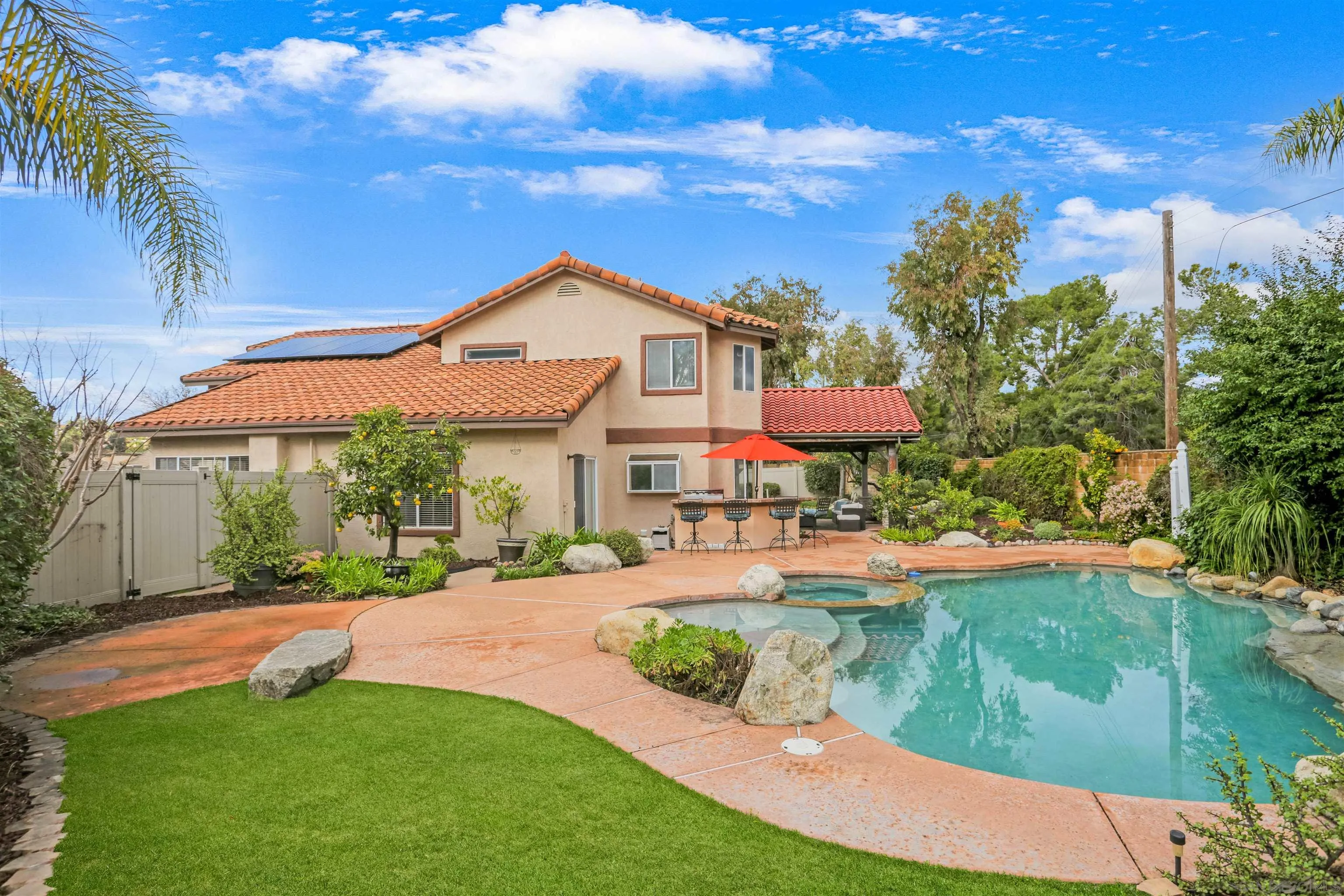 14153 Rio Court Poway, CA 92064 - Photo 40 of 48 a front view of a house with yard swimming pool and outdoor seating