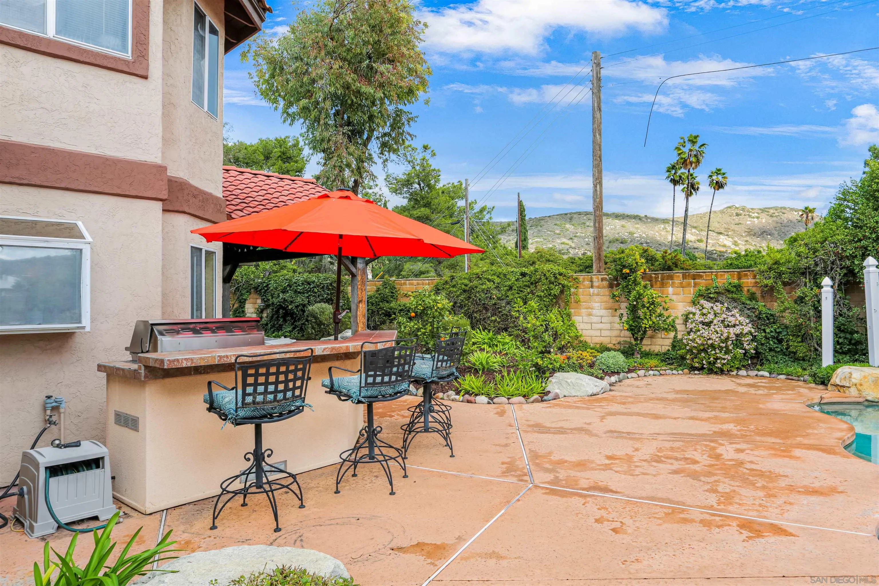 14153 Rio Court Poway, CA 92064 - Photo 44 of 48 a view of a patio with table and chairs under an umbrella