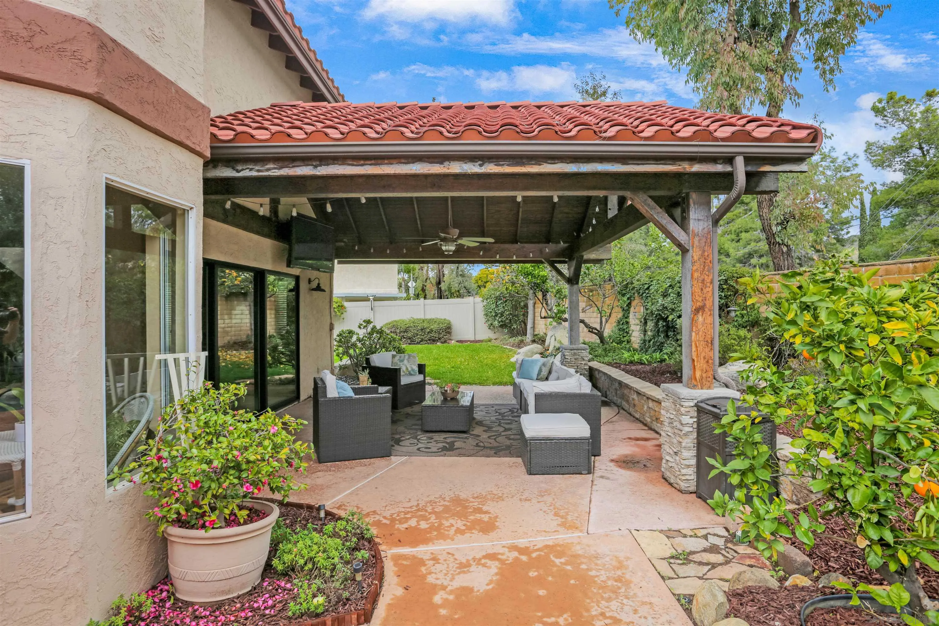 14153 Rio Court Poway, CA 92064 - Photo 45 of 48 a view of a patio with table and chairs potted plants