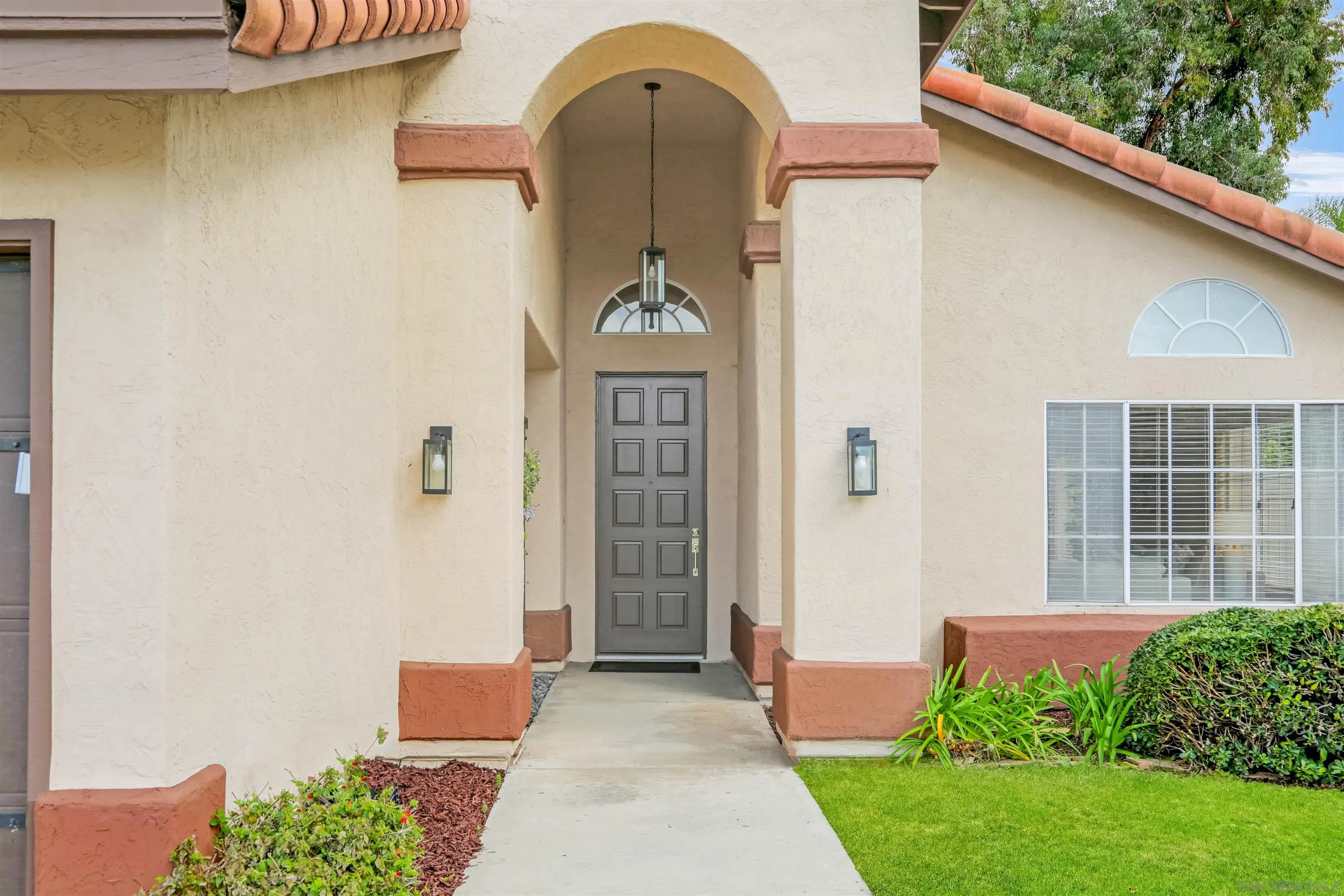 14153 Rio Court Poway, CA 92064 - Photo 5 of 48 a front view of a house with a garden