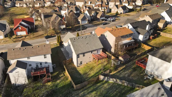 an aerial view of a house with a yard