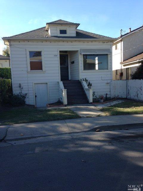 a view of a house with a small yard