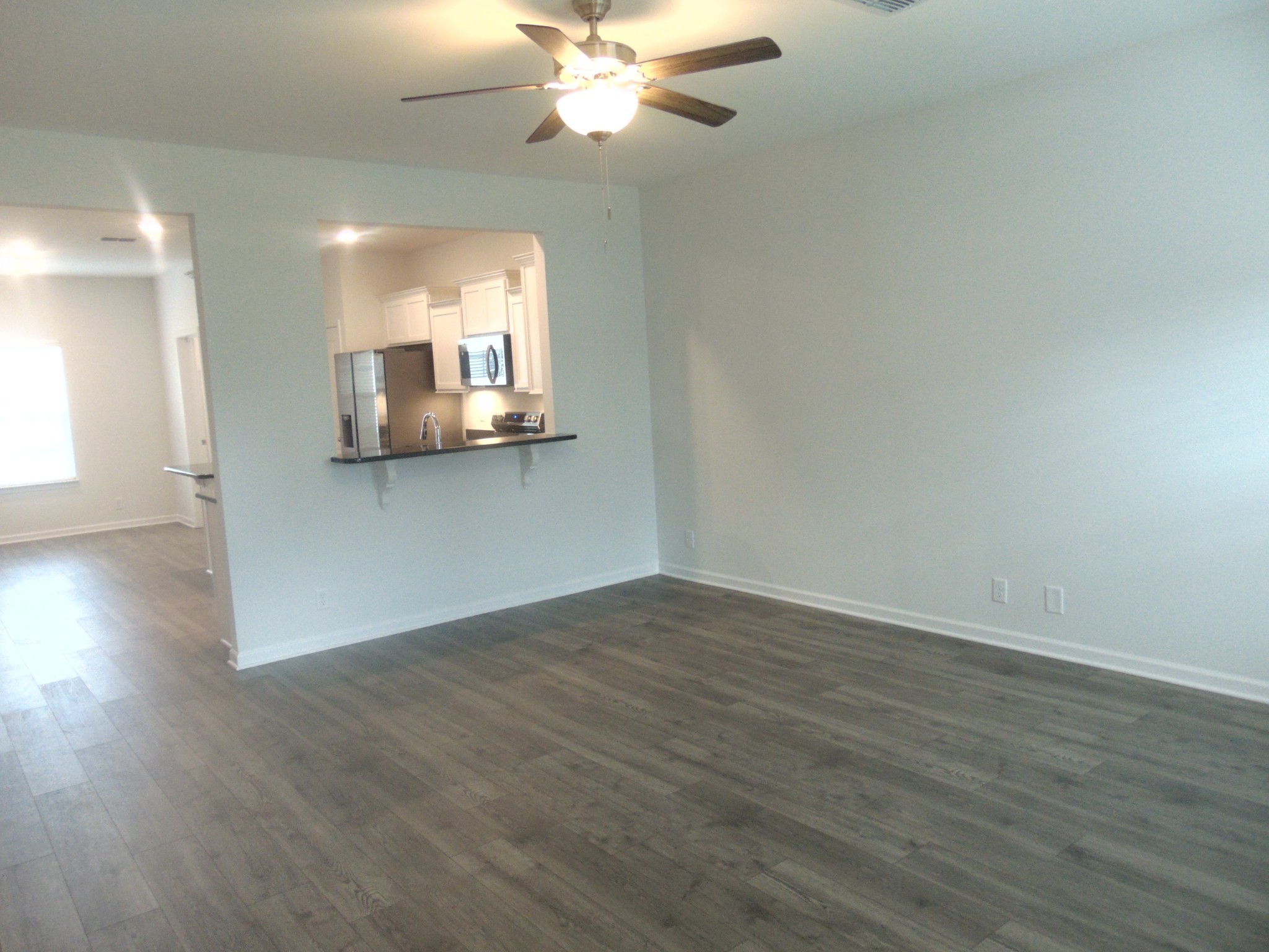 281 Spring Street La Vergne, TN 37086 - Photo 2 of 26 a view of a kitchen with wooden floor and a ceiling fan